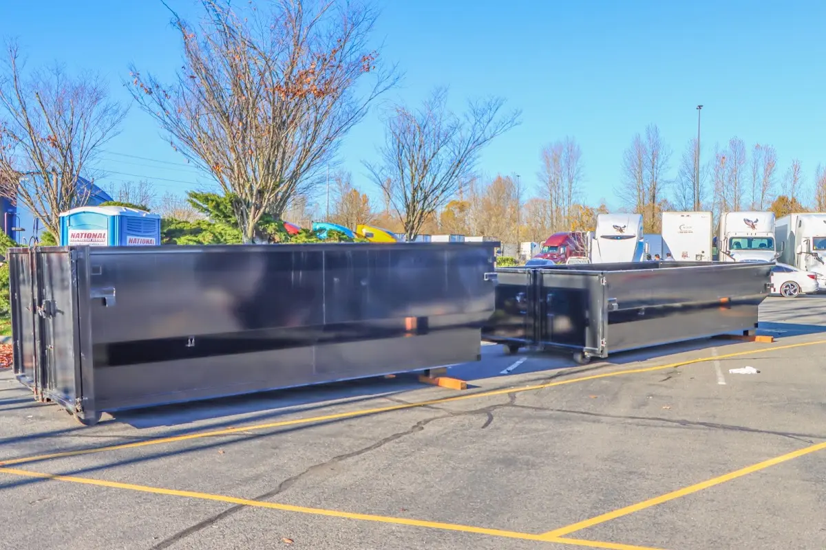 Professional dumpster rental service with roll-off container on residential driveway in Glen Cove